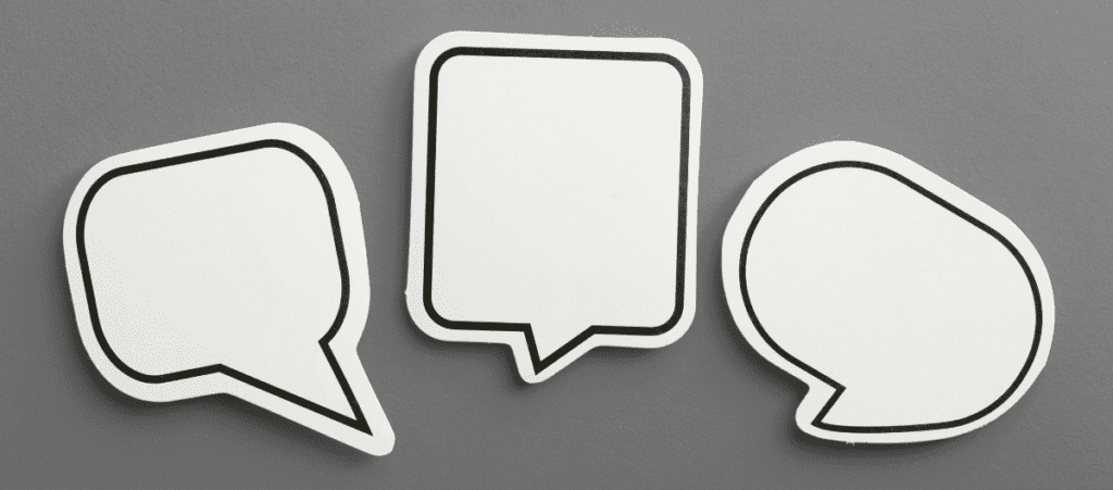 white speech bubbles on gray background representing What Your Social Media Says About Your Brand blog
