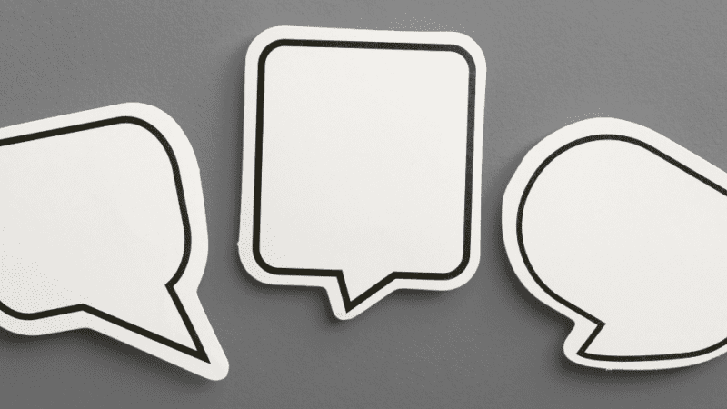 white speech bubbles on gray background representing What Your Social Media Says About Your Brand blog