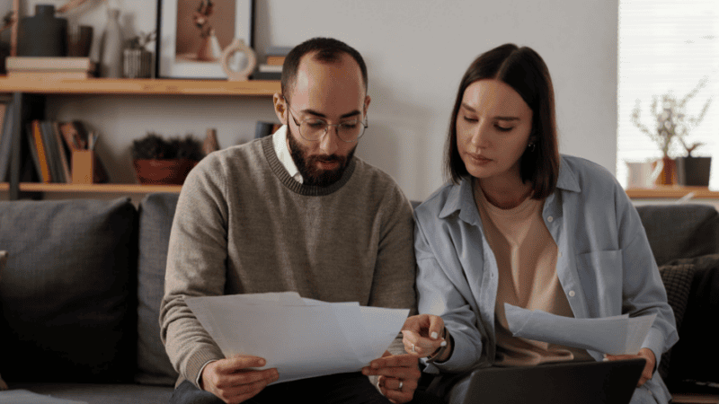SEO and AI Visibility Case Study - Branch Based Financial Lender - image of couple with bills