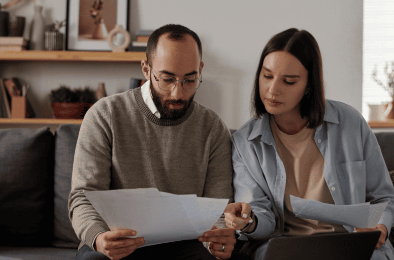 SEO and AI Visibility Case Study - Branch Based Financial Lender - image of couple with bills