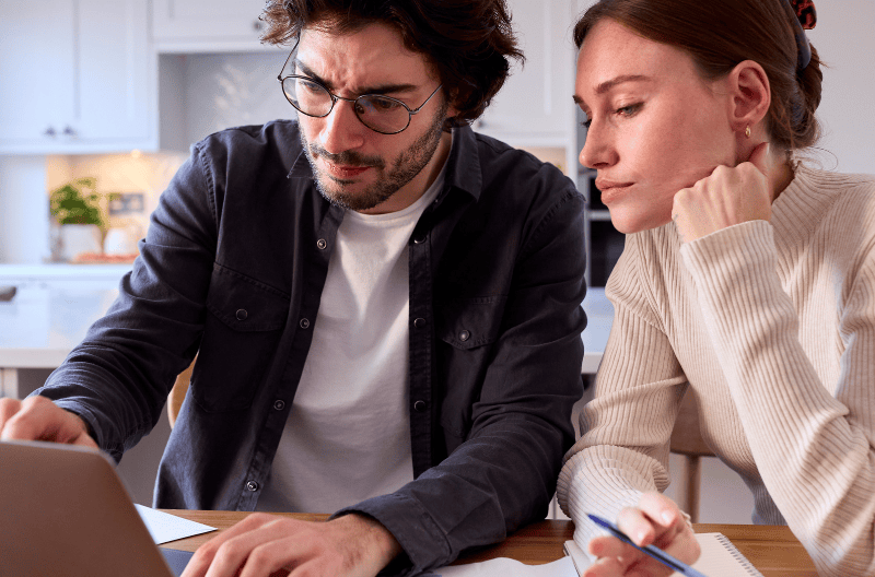 SEO and AI Visibility Case Study - Online Installment Lender - image of couple on computer pointing